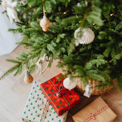 Beautifully wrapped Christmas presents under a decorated tree, symbolising thoughtful and festive gift-giving ideas for the holiday season.